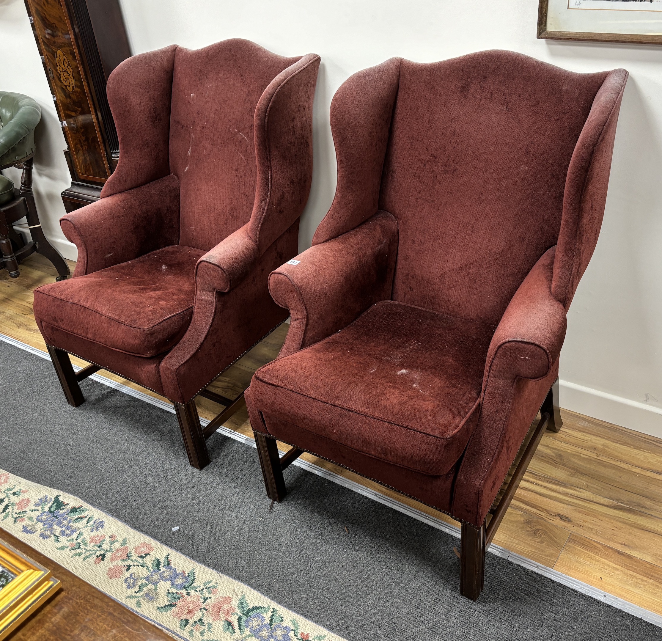 A pair of George III style upholstered wing armchairs, width 78cm, depth 80cm, height 105cm